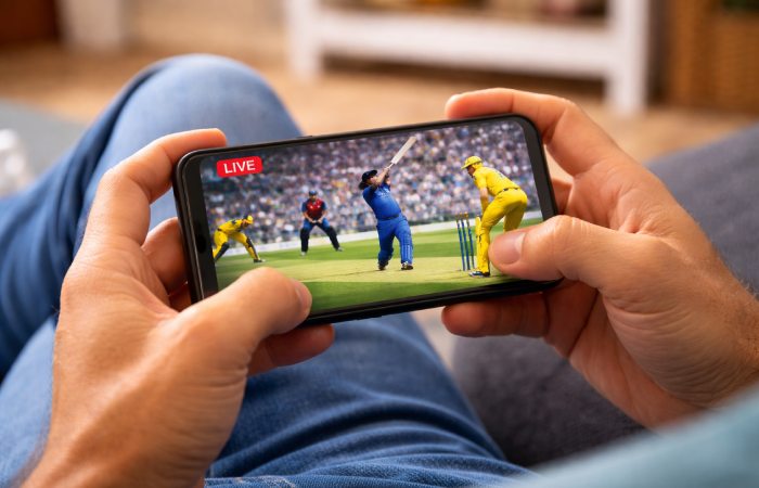 cricket fan watching a live match on a smartphone indoors